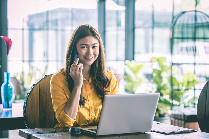 Woman talking on telephone and smiling