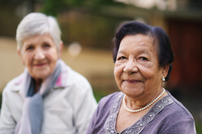 Two elderly women smiling